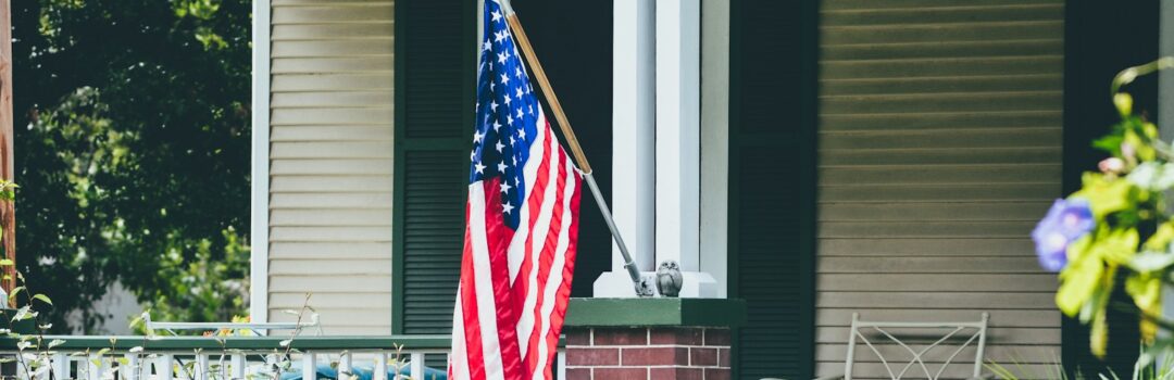 us a flag on white wooden fence