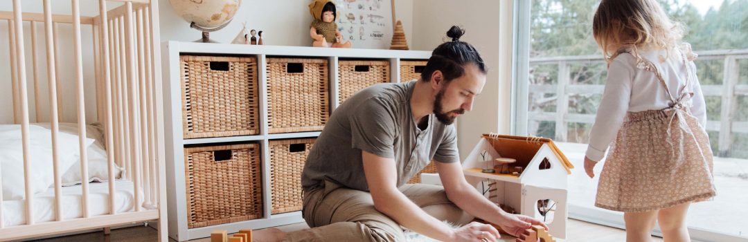 father and daughter playing blocks in daughter's room